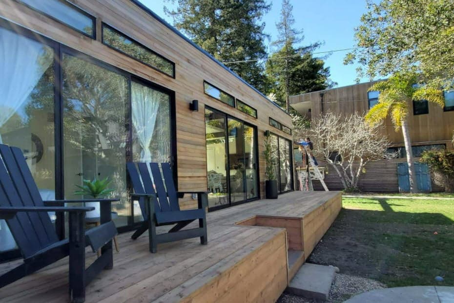 Digz 900 wood-clad modular ADU with deck and sliding glass