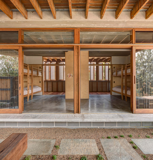 Two volumes joined by an open deck — the two-pavilion concept